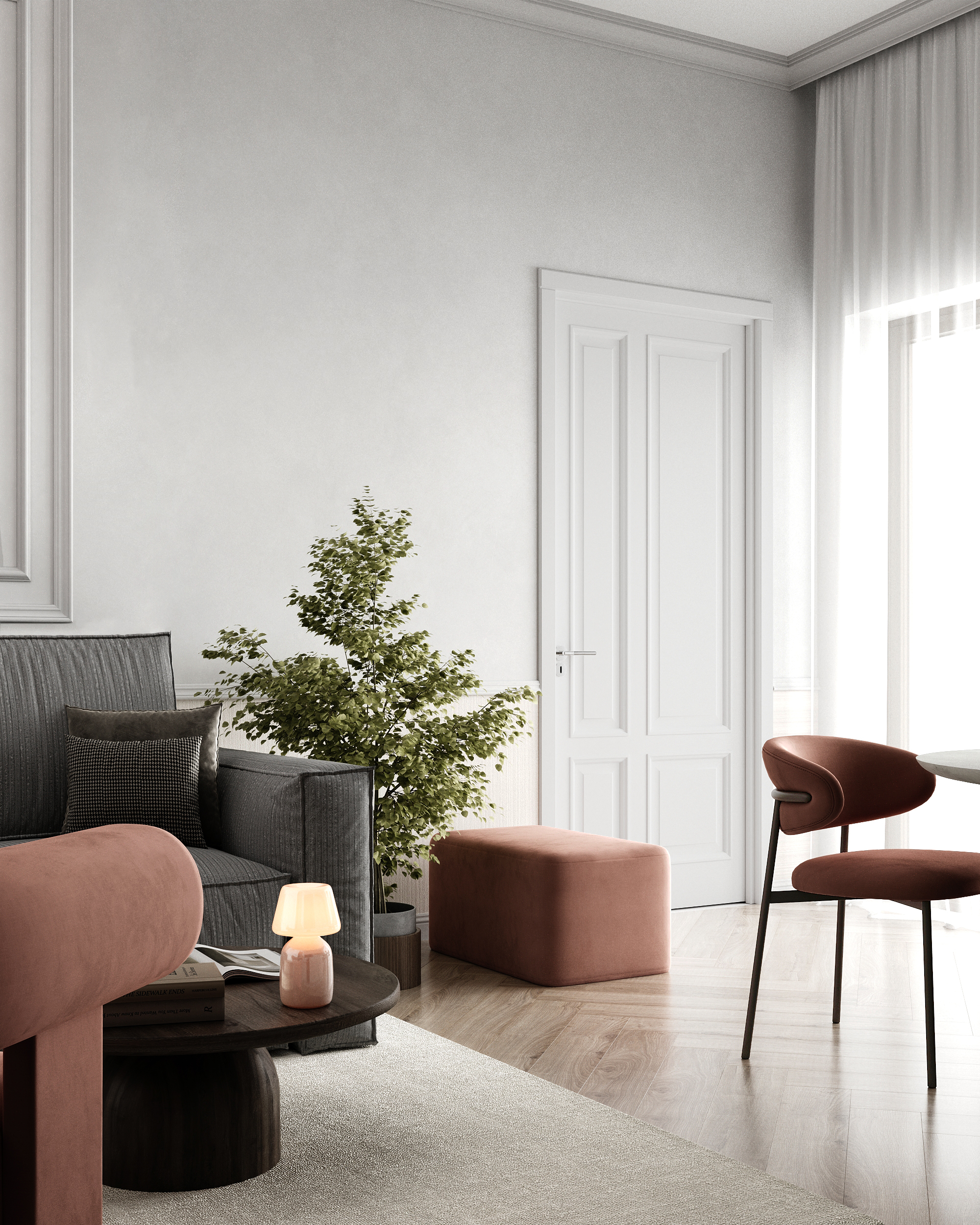 Wohnbereich mit grauem Sofa, altrosa Sessel und Hocker vor einer Altbautür